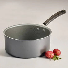 Gray non-stick sauce pan with dark handle and silver cooking surface
