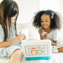 Pretend makeup play set case held by a child, showing Love Your Look label