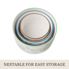 Stacked nesting baker bowls with lids showing rims for storage, floral stoneware