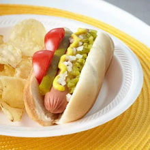 White foam lunch plate holding a hot dog with relish and onions
