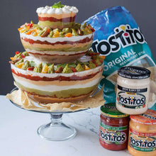 Creamy spinach dip jar among other dip jars and tortilla chips