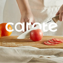 Ceramic kitchen knife slicing tomatoes on a wooden board, cream handle