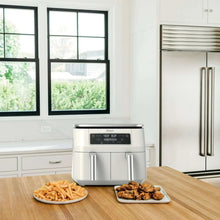 White air fryer on kitchen counter with two drawer-style cooking compartments