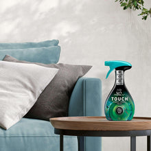 Febreze Touch fabric spray bottle with teal trigger sprayer on table