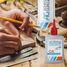 CA cyanoacrylate glue bottle with red cap for woodworking on a workbench