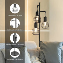 Black floor lamp with industrial caged bulb shades and stable round base