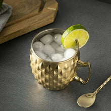 Gold stainless steel Moscow mule mug with diamond texture, ice, and lime wedge on rim