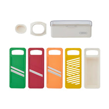 Mandoline blade covers in green, red, orange, yellow, and white, with storage caps.