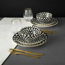 Black-and-white ceramic plates and bowls with triangle medallion pattern and rim details