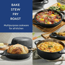 Black enameled Dutch oven with lid, showing bread loaf and a soup dish.