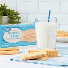 Vanilla creme wafer cookies with milk glass and straw