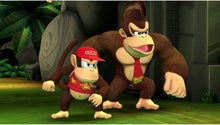 Nintendo Switch platformer game screenshot: Donkey Kong and Diddy crouching in green-lit area