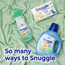 Snuggle SuperFresh fabric softener bottles on green cloth, top view