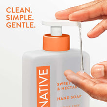 Native hand soap dispenser with orange pump, Sweet Peach & Nectar, dispensing onto hands