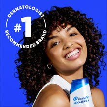 Itchy scalp care shampoo bottle held near a smiling woman, blue cap