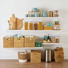Kitchen shelf with clear flip-top storage containers filled with baking ingredients