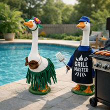 Goose statue with flower crown, holding a spatula, wearing a green grass skirt.