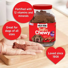 Milk-Bone Soft & Chewy dog treats jar with brown bone treats and a hand