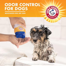 Arm & Hammer odor control dog shampoo bottle being used on a small dog on a towel.