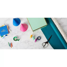 Transparent tape roll on desk with crafting supplies