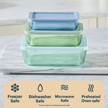 Stacked tinted plastic rectangle food storage containers with blue and green lids