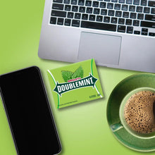 Wrigley’s Doublemint gum wrapper on a desk with laptop and mug