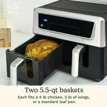 11-qt dual-basket air fryer with open baskets, one basket holding roasted food, black
