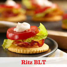 Crackers topped with BLT fillings and a dollop of creamy sauce