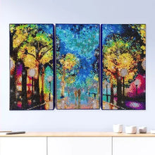 Three finished diamond painting panels featuring colorful trees and glowing scene