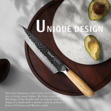 Damascus chef knife with light wood handle and dark patterned hammered blade
