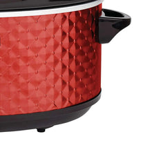 Red slow cooker with diamond-pattern exterior and black side handles, close-up view.