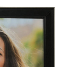 Black picture frame corner with inner photo border, close-up