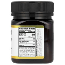 Manuka honey jar with black lid; back Nutrition Facts panel.
