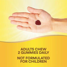 Hand holding a single strawberry gummy