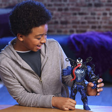 Venom-style action figure held in hands, blue suit and black tentacle details
