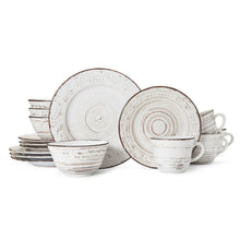 White stoneware dinnerware set with stack of plates, bowls, and handle mugs