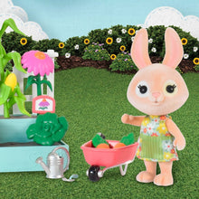 Bunny figure with wheelbarrow holding orange and green vegetables next to garden planter