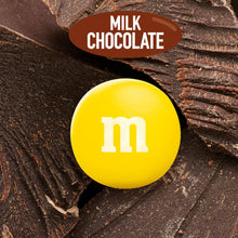 Yellow M&M milk chocolate candy on chocolate pieces