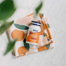 Vitamin D3 softgel supplement bottle on a patterned surface with a plant leaf nearby