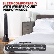 Black tower fan standing next to a bedside lamp