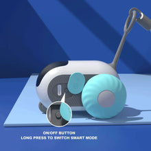 Automatic cat toy roller close-up showing on/off button and teal side wheel