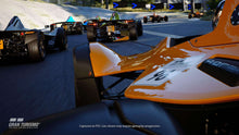 PS5 racing game track scene screenshot with race cars and Gran Turismo logo