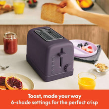 Plum 2-slice toaster on kitchen counter with toasting lever and shade dial