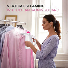 Portable handheld garment steamer steaming a pink shirt on a hanging rack