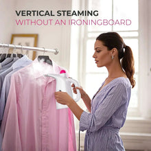 Portable garment steamer steaming a hanging shirt on a rack, handheld white unit