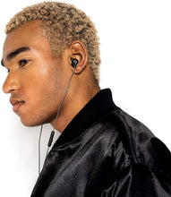 Black wired in-ear headphones worn with earbud fit and inline microphone