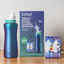 Iridescent teal stainless steel bottle with starter kit box and two flavor cartridge boxes