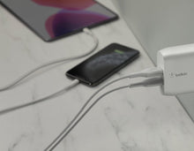 Belkin dual-port wall charger with USB cable connected to devices