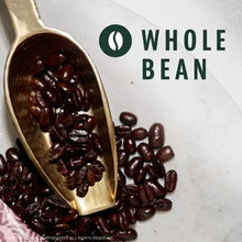 Whole bean coffee with wooden scoop and scattered dark roasted beans