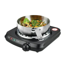 Single coil electric hot plate with skillet heating mixed vegetables on the burner